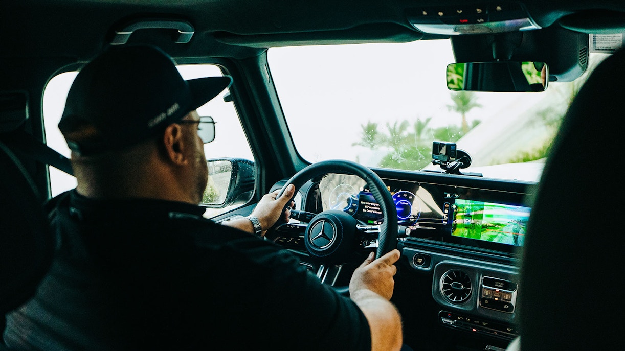 Tourist driving Mercedes-Benz at Mercedes-Benz Experience Dubai.