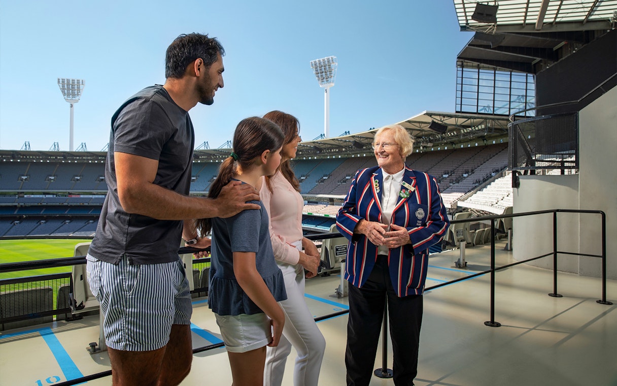 Tour group with guide at Melbourne Cricket Ground stadium.