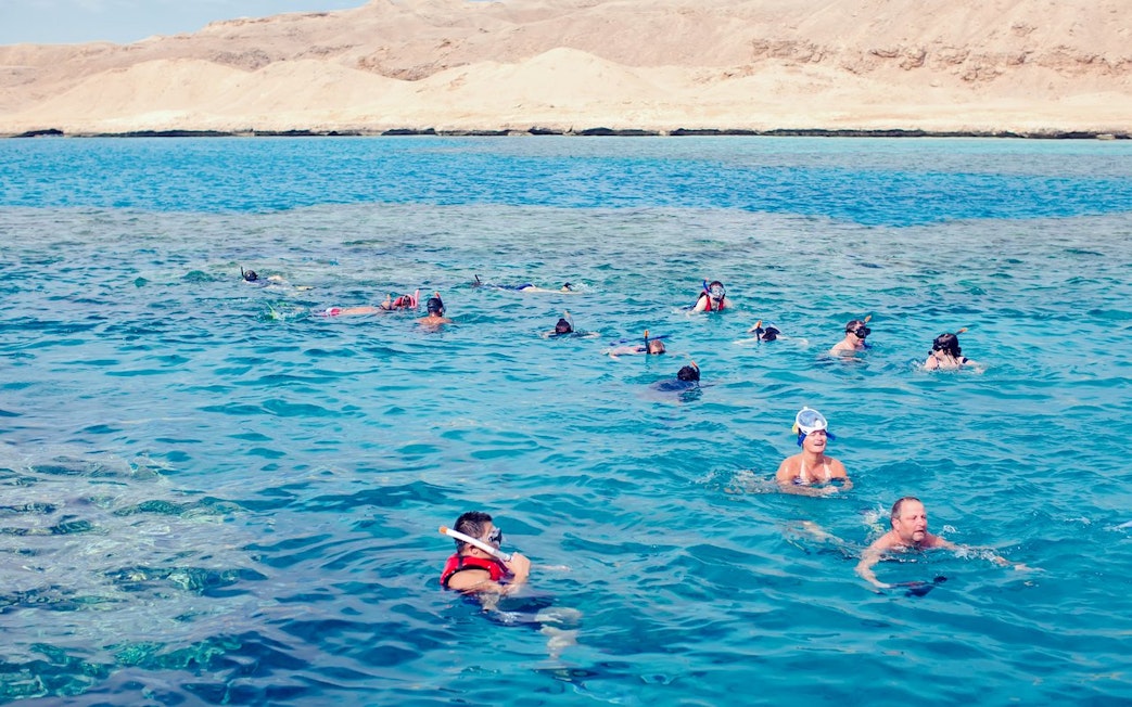 Snorkelers exploring coral reefs and marine life in the Red Sea, Hurghada.