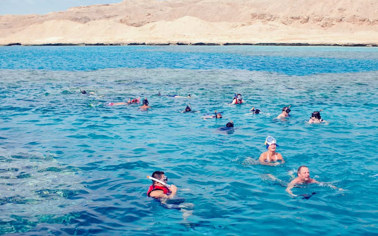Snorkelers exploring coral reefs and marine life in the Red Sea, Hurghada.