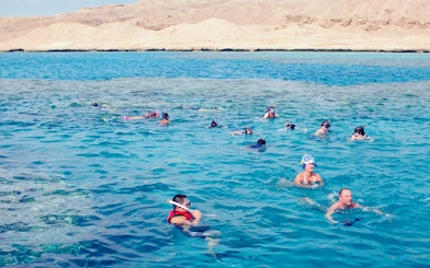 Snorkelers exploring coral reefs and marine life in the Red Sea, Hurghada.