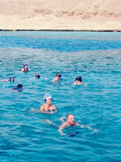 Snorkelers exploring coral reefs and marine life in the Red Sea, Hurghada.