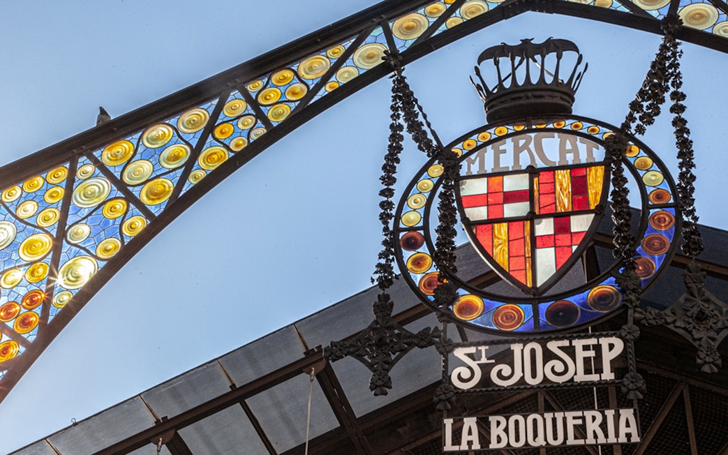 La Boquería market entrance sign with colorful stained glass in Barcelona.