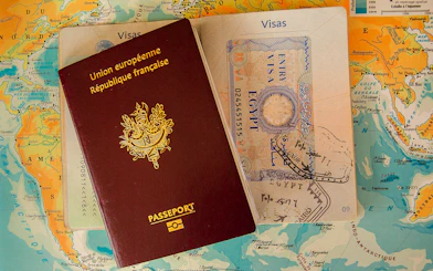 Passport and visa on a world map, representing Vietnam E-Visa application service for Nha Trang.