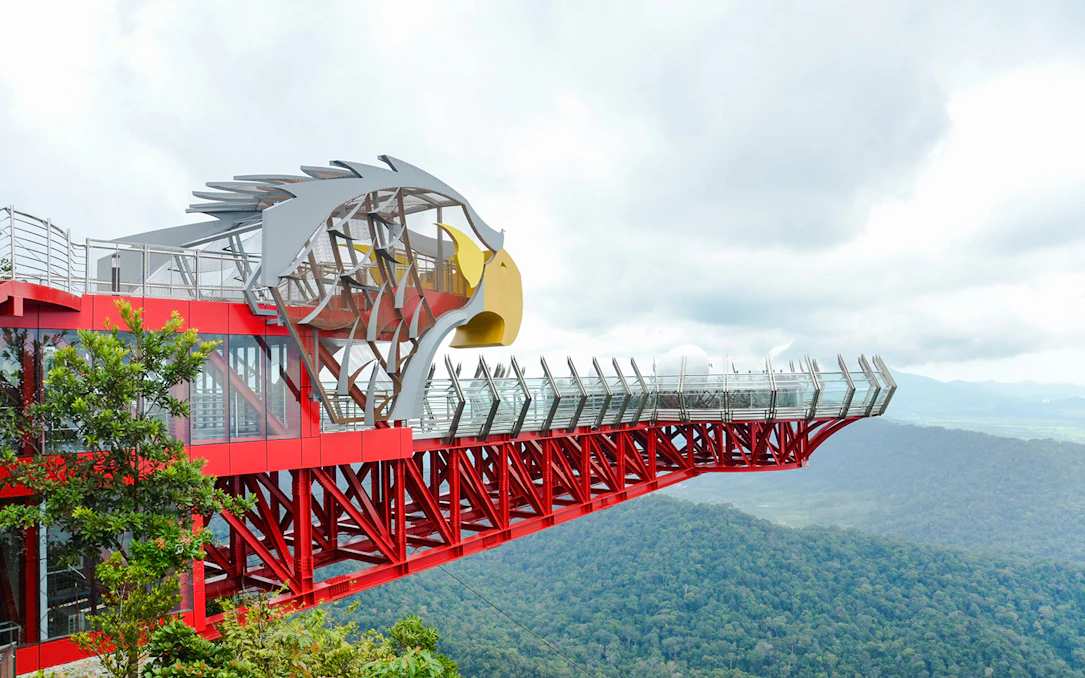 Langkawi Skywalk with eagle-themed structure overlooking lush green forest.
