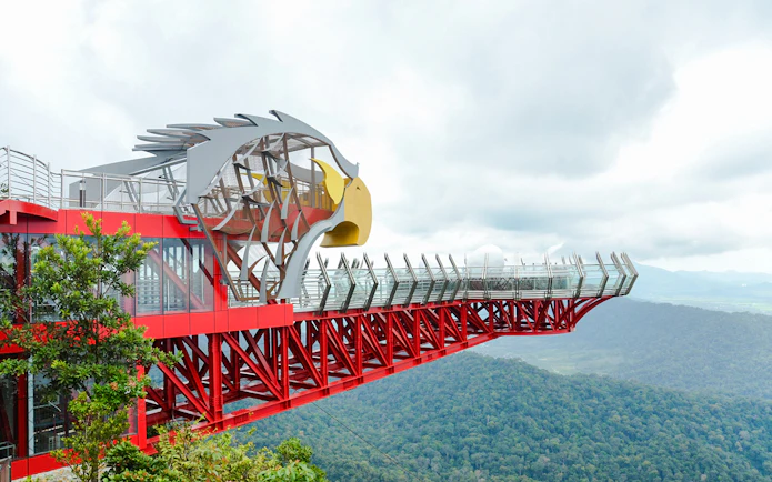 Langkawi Skywalk with eagle-themed structure overlooking lush green forest.