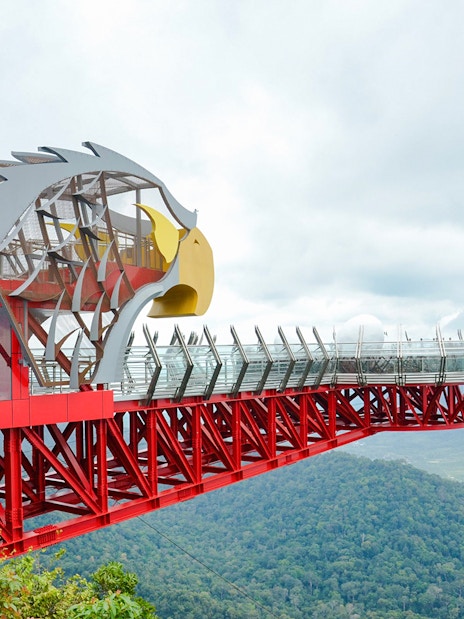 Langkawi Skywalk with eagle-themed structure overlooking lush green forest.