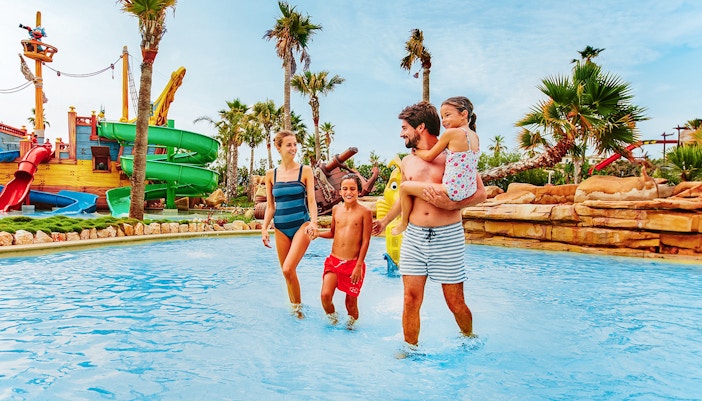 Family having fun at Caribe Aquatic Park in PortAventura, Spain.