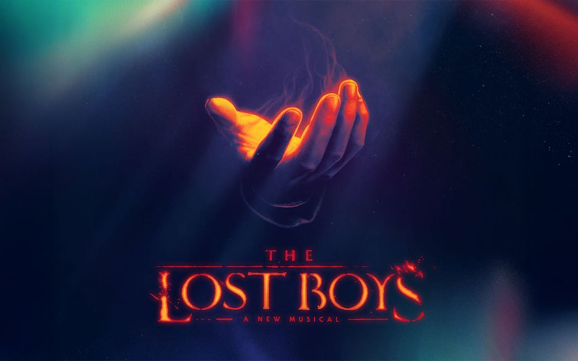 Hand with glowing light above "The Lost Boys" Broadway musical title.