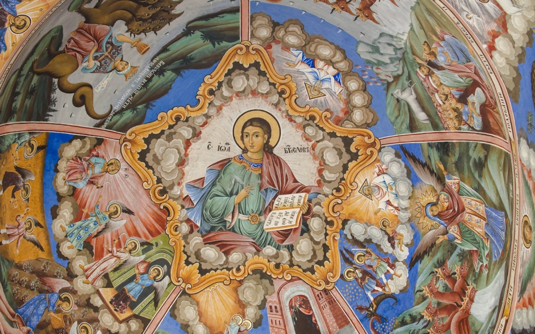 Religious frescoes depicting biblical scenes on the church wall in Rila Monastery, Bulgaria.