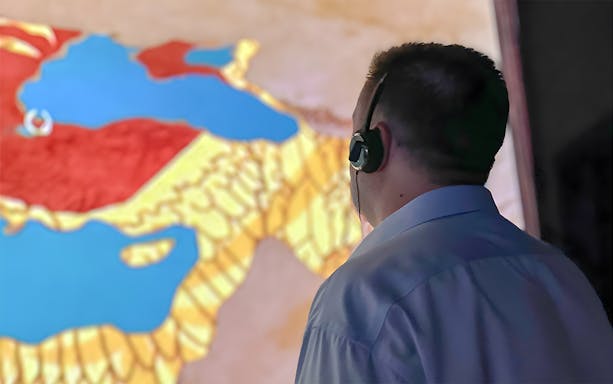 Person with headset viewing map during Hagia Sophia guided tour.