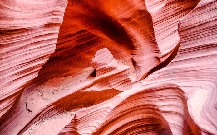 Reddish sandstone formations in Rattlesnake Canyon, showcasing layered textures.