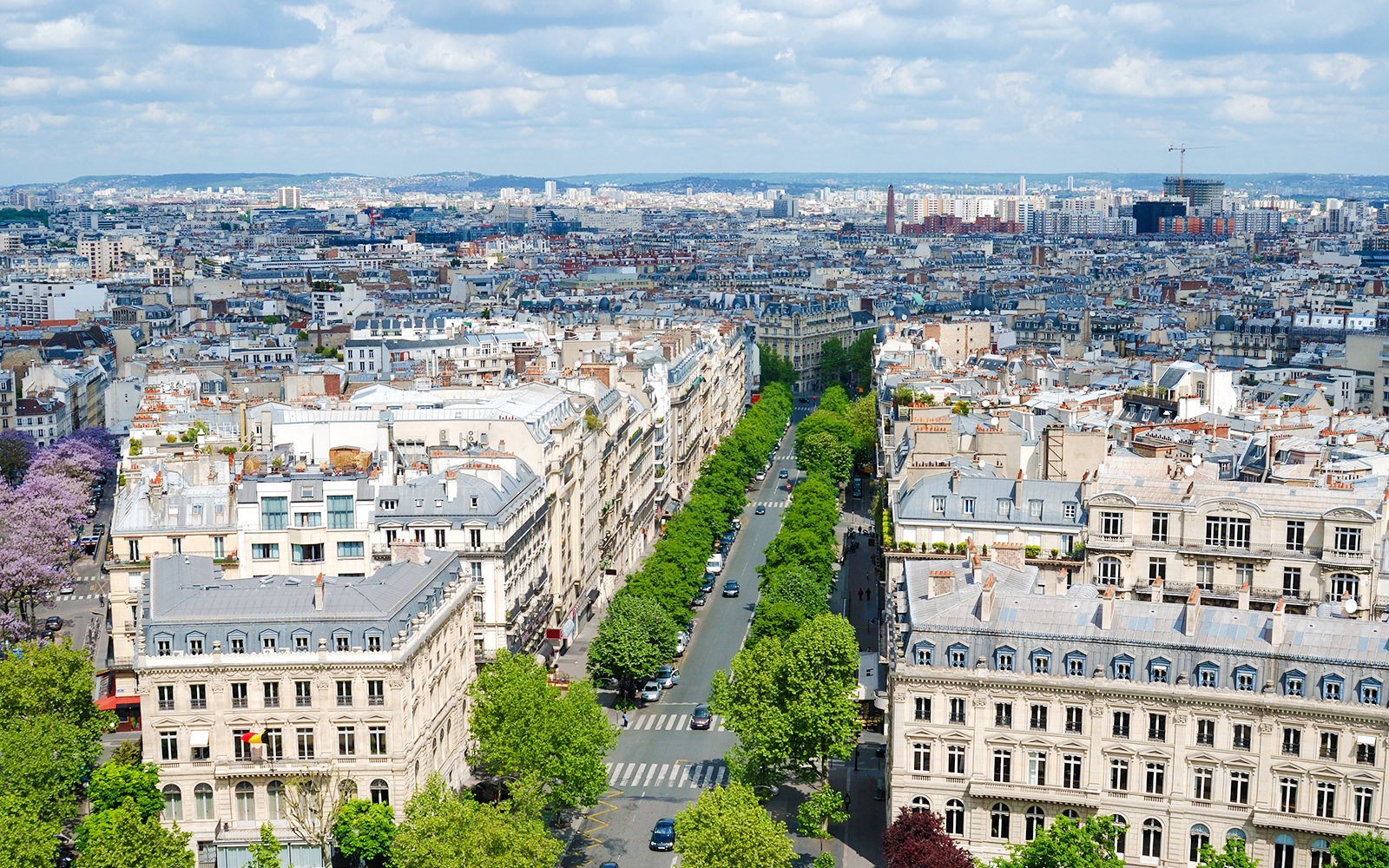 Avenue Foch in Paris, lined with trees and classic Haussmann buildings, viewed from above.