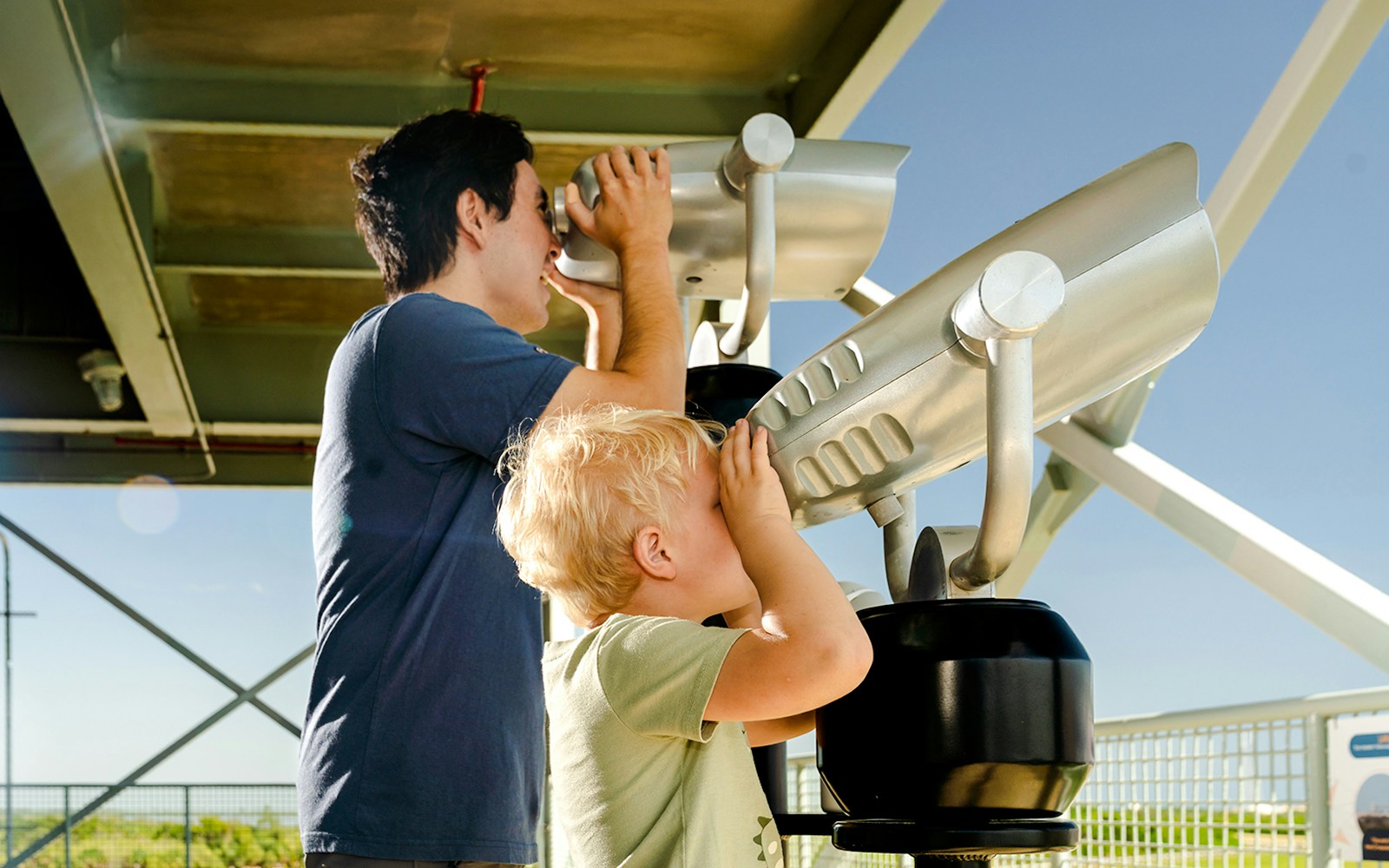 Family using binoculars at LC-39 gantry to view a launch.