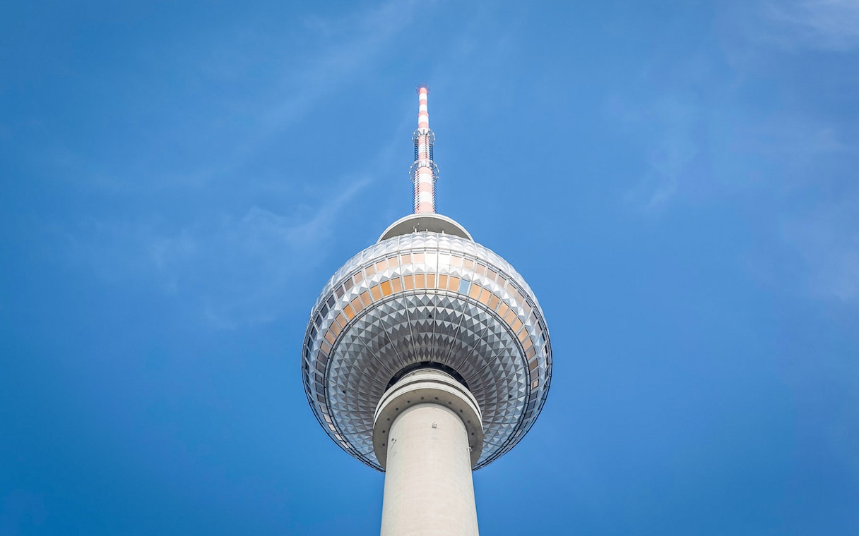 Berlin TV Tower closeup against blue sky.