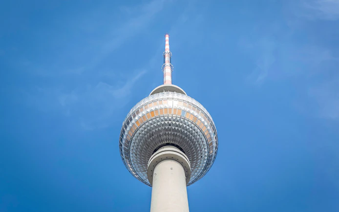 Berlin TV Tower closeup against blue sky.