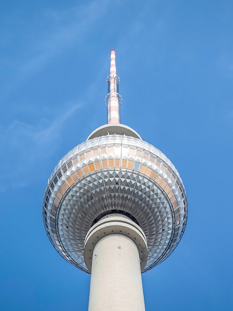 Berlin TV Tower closeup against blue sky.
