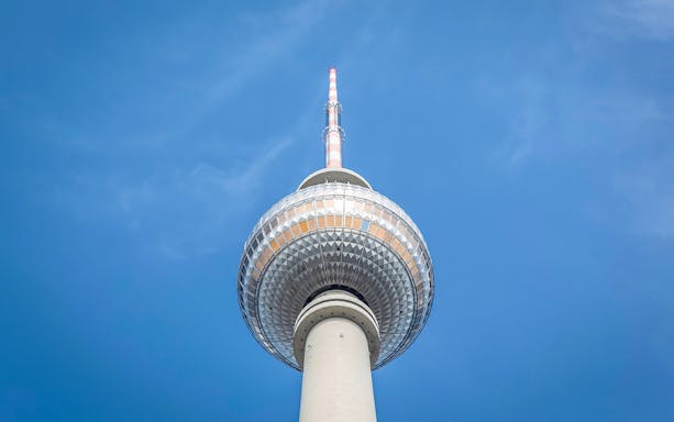 Berlin TV Tower closeup against blue sky.