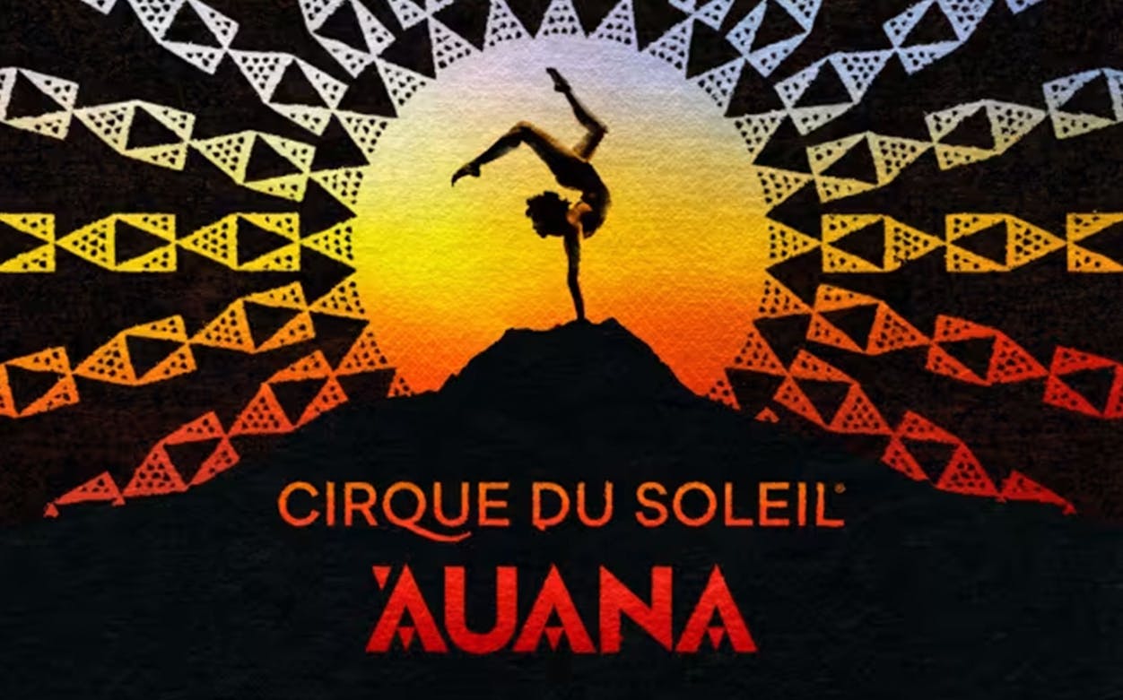 Performer balancing on one hand against a vibrant sunset backdrop, Cirque du Soleil Auana.