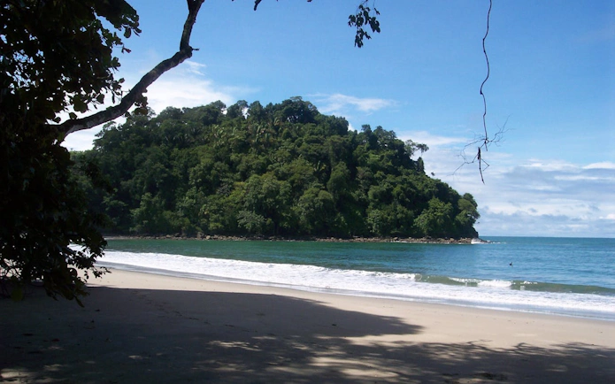 Beach and lush forest view at Manuel Antonio National Park, Costa Rica.