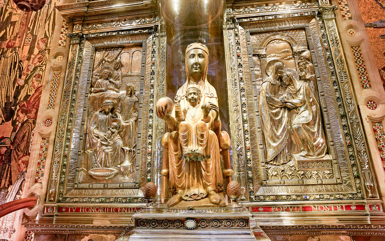 Montserrat Monastery's Black Madonna statue in ornate gold setting.