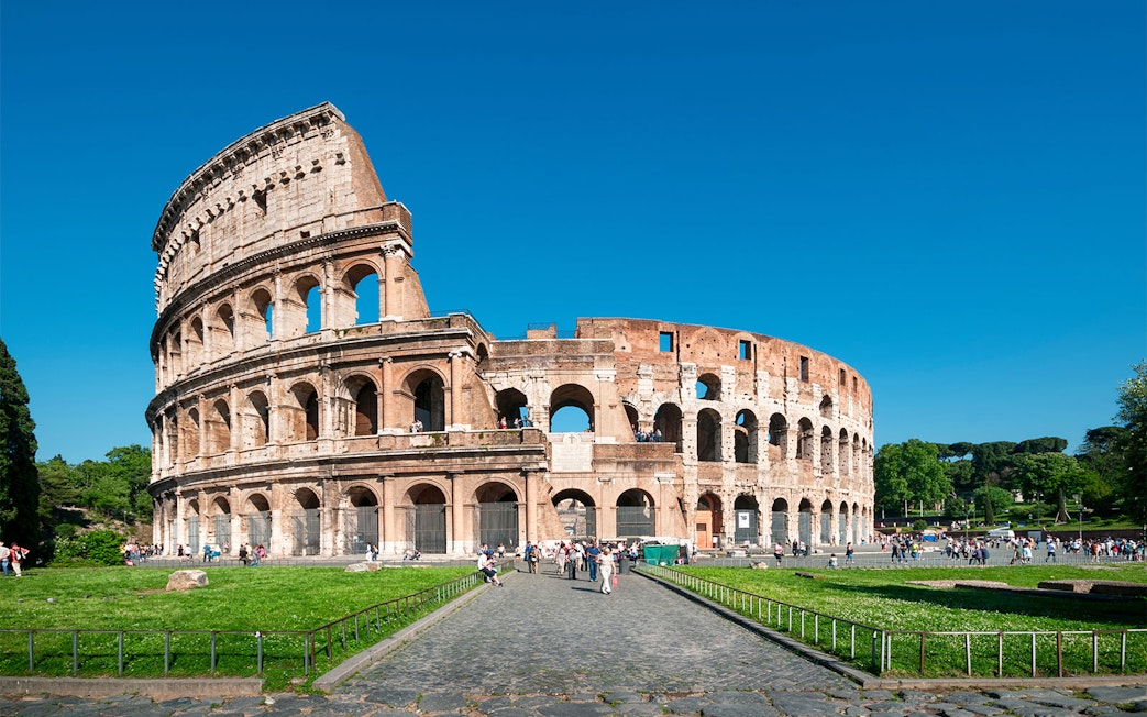 Colosseum facade with tourists, Rome, Italy.