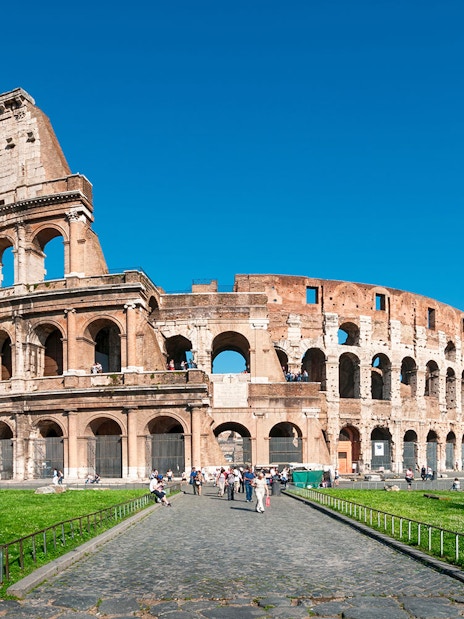 Colosseum facade with tourists, Rome, Italy.