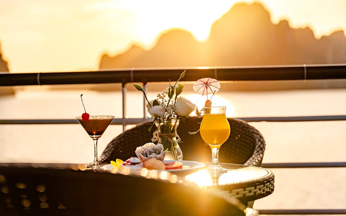 Cocktails and snacks on a table during sunset at Hercules Luxury Cruise party.