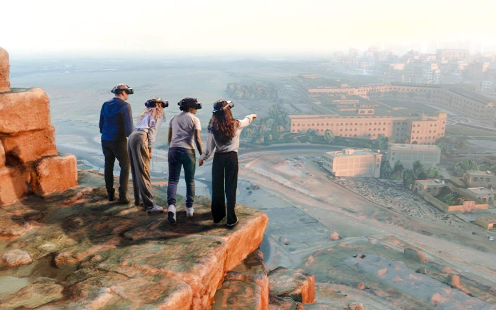 Guests using VR headsets to explore ancient Egypt from a cliff, Horizon of Khufu experience.