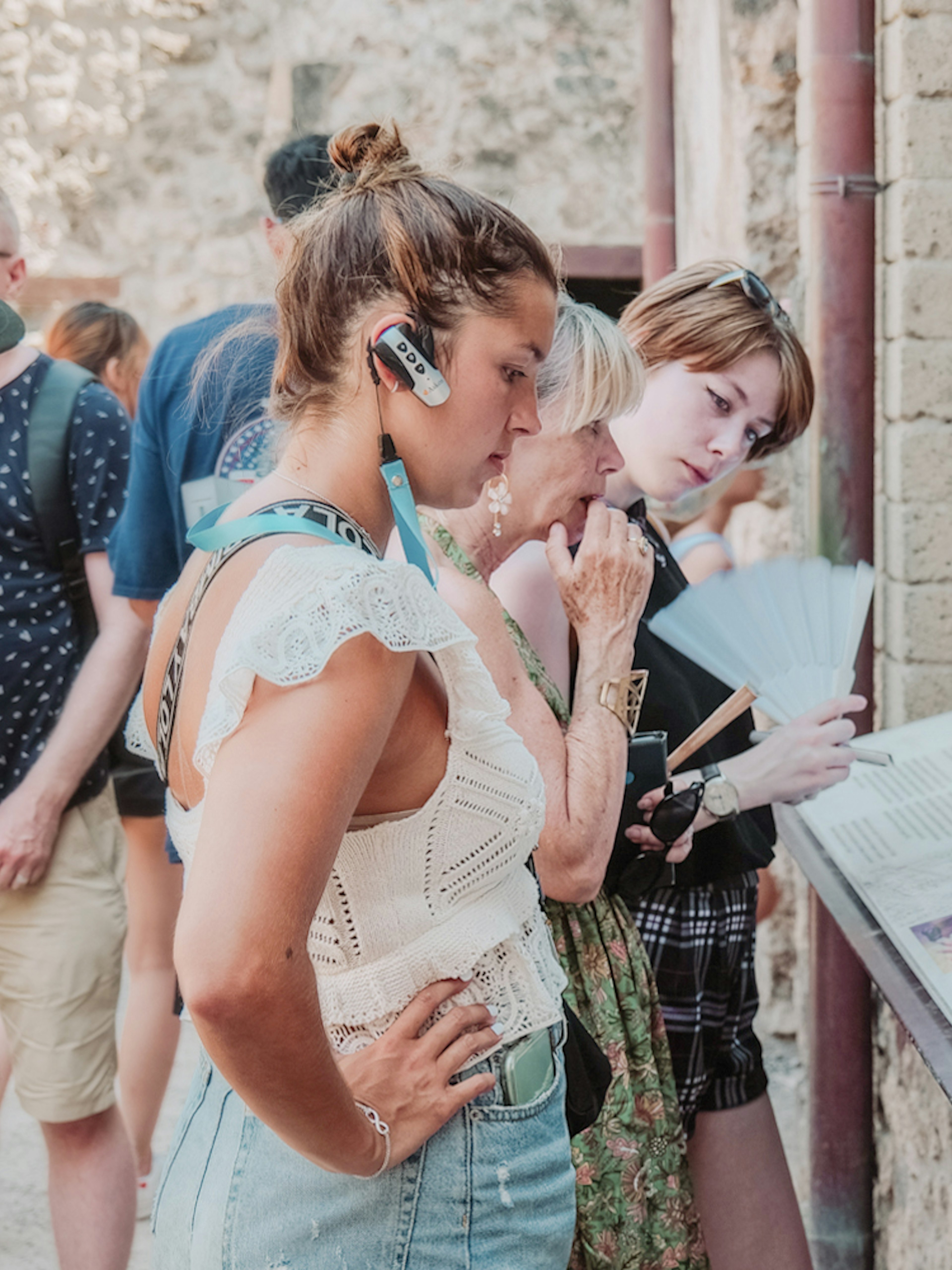 Visitors reading information plaques on a Pompeii VIP small group tour.