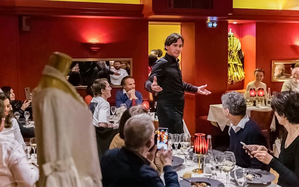 Performer engaging audience at Bel Canto interactive dinner show.