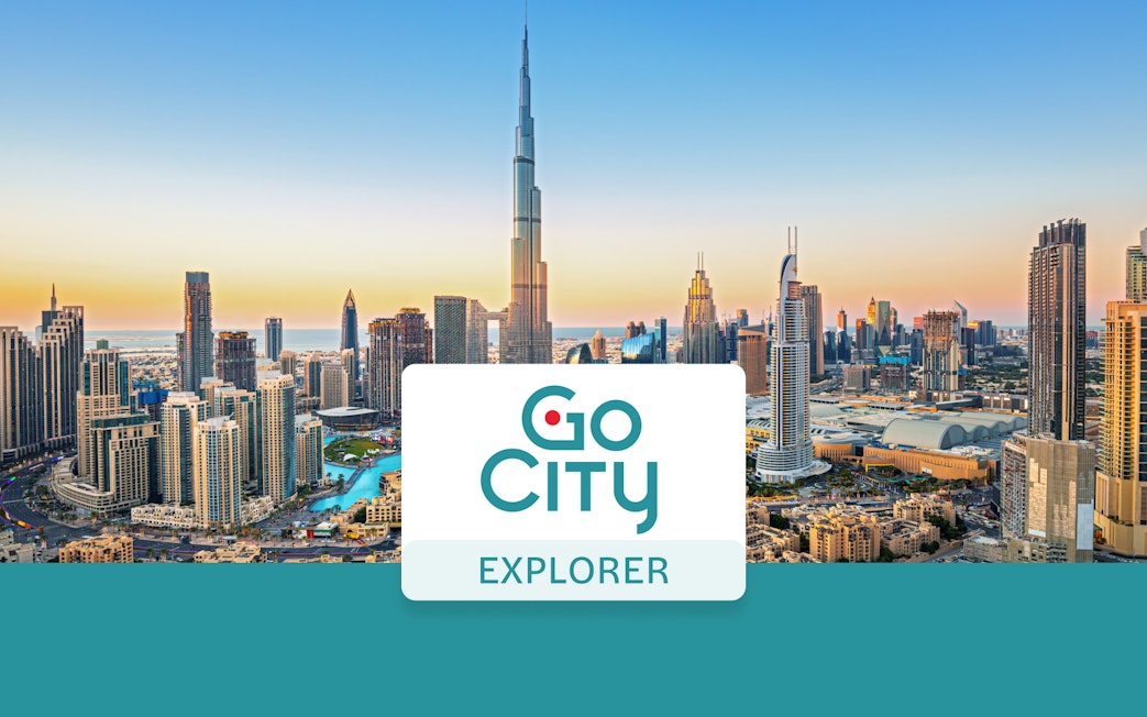 Dubai skyline with Burj Khalifa at sunset, promoting Go City: Dubai Explorer Pass.
