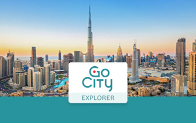 Dubai skyline with Burj Khalifa at sunset, promoting Go City: Dubai Explorer Pass.