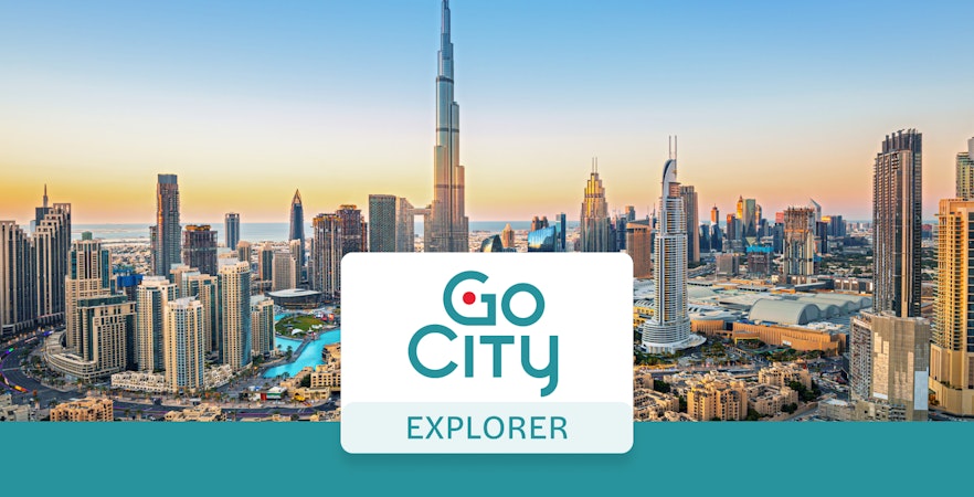 Dubai skyline with Burj Khalifa at sunset, promoting Go City: Dubai Explorer Pass.