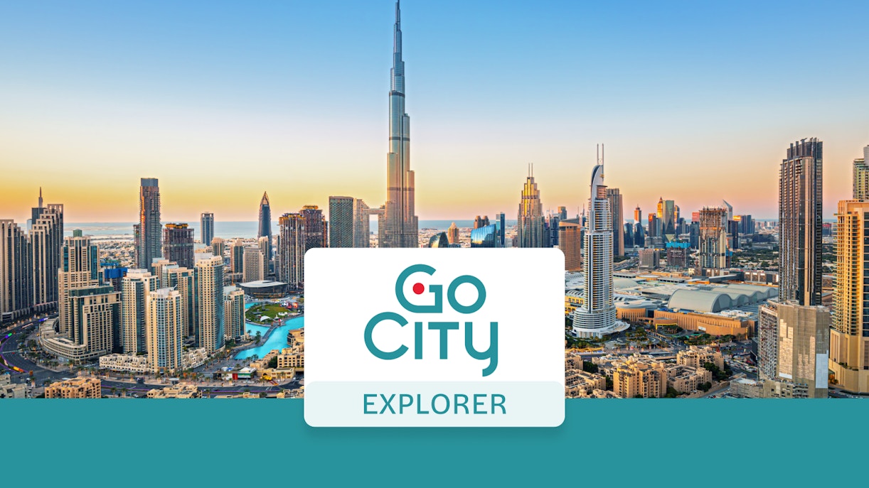 Dubai skyline with Burj Khalifa at sunset, promoting Go City: Dubai Explorer Pass.
