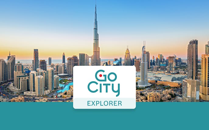 Dubai skyline with Burj Khalifa at sunset, promoting Go City: Dubai Explorer Pass.