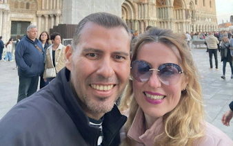 Couple smiling in front of St. Mark's Basilica, Venice, during Casanova's city exploration game.