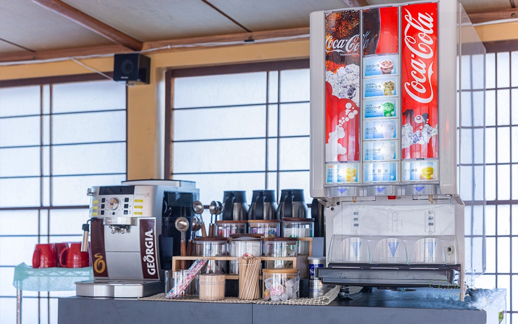 Beverage station with coffee machine and soda dispenser on Yakatabune dinner cruise.