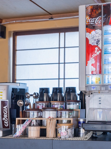 Beverage station with coffee machine and soda dispenser on Yakatabune dinner cruise.