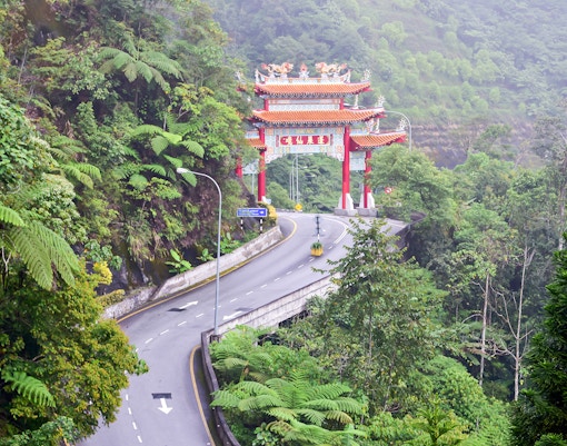 Chin Swee Caves Temple with intricate pagoda and lush forest backdrop in Genting Highlands, Malaysia.