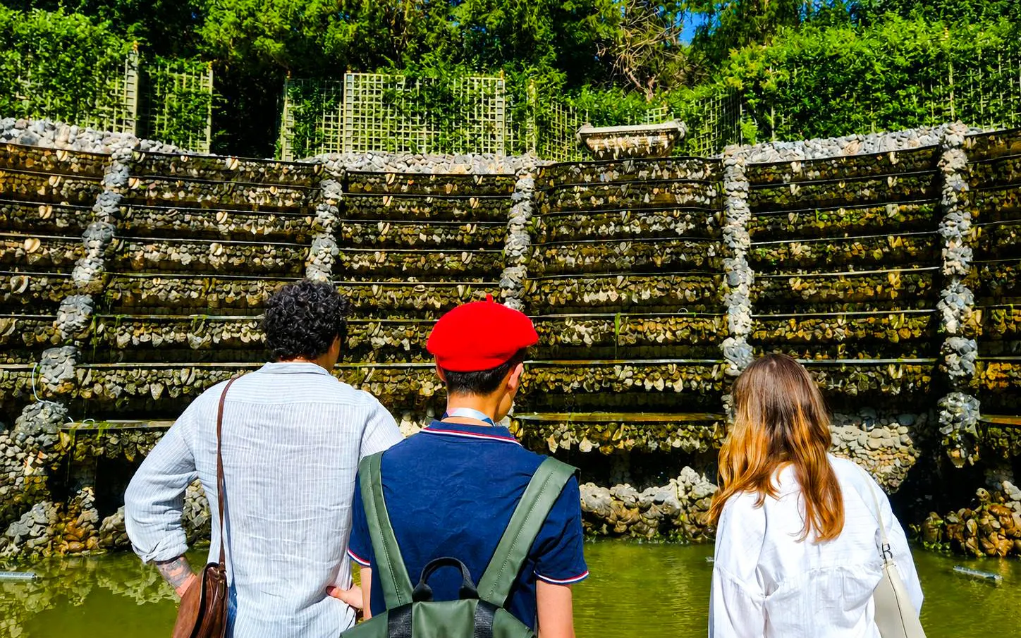 Visitors exploring the rockwork of Versailles Palace Royal Gardens.