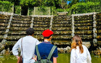 Visitors exploring the rockwork of Versailles Palace Royal Gardens.