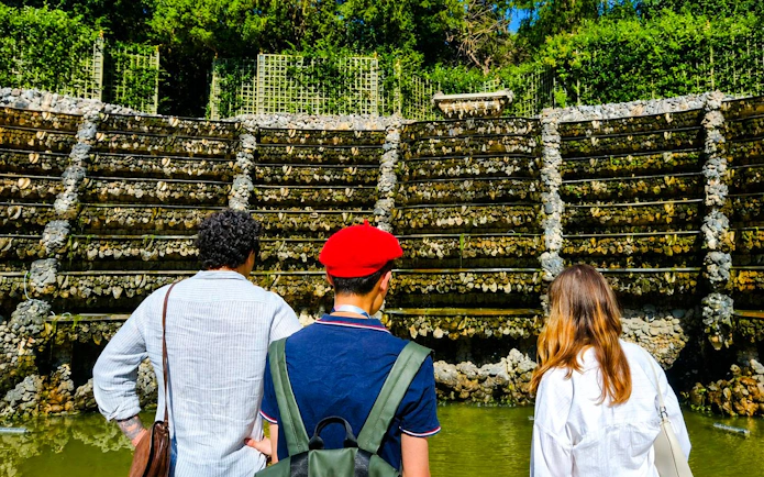 Visitors exploring the rockwork of Versailles Palace Royal Gardens.