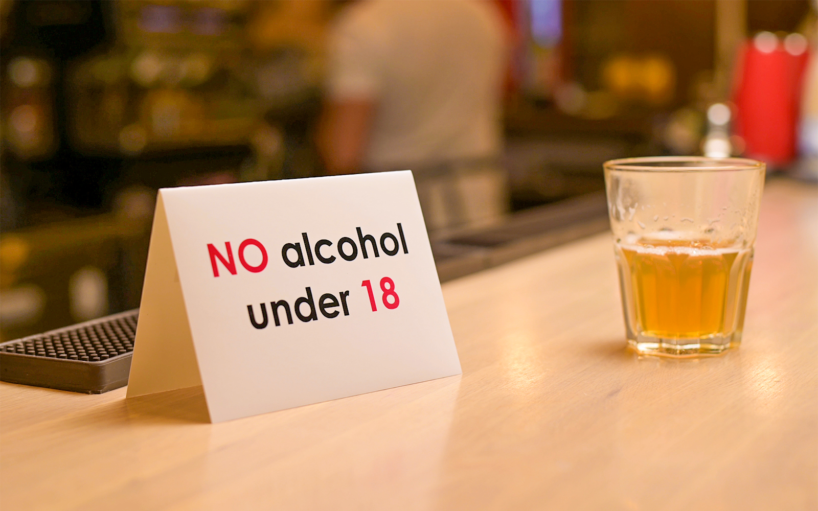 Beer tasting session with age limit sign at a bar in Munich, Germany.
