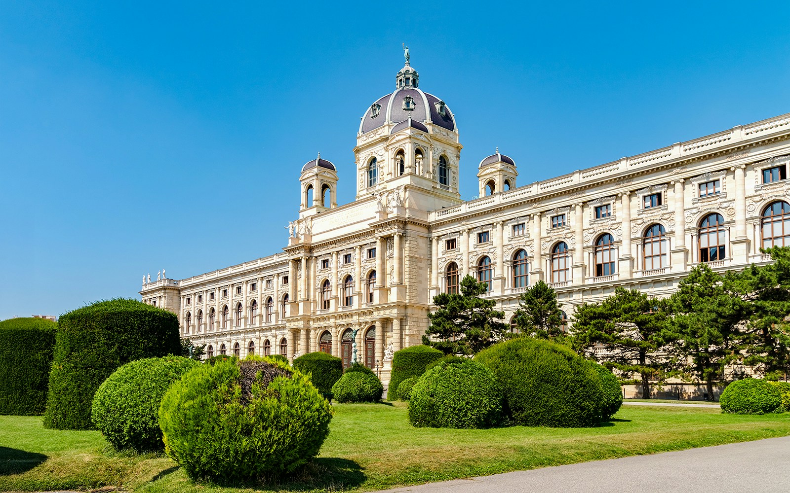 Natural History Museum Vienna exterior with grand architecture and visitors exploring the entrance.