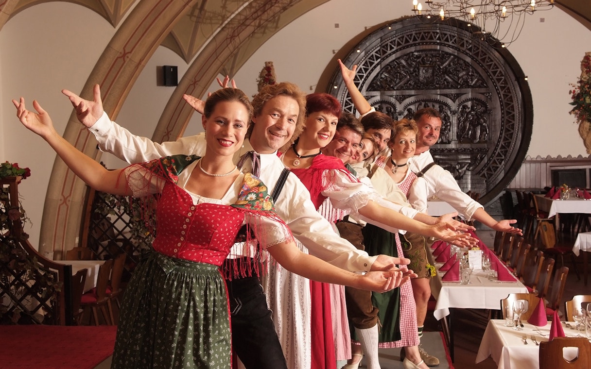 Performers in traditional attire at Waltz- & Operetta Dinner Show, Vienna city hall restaurant.