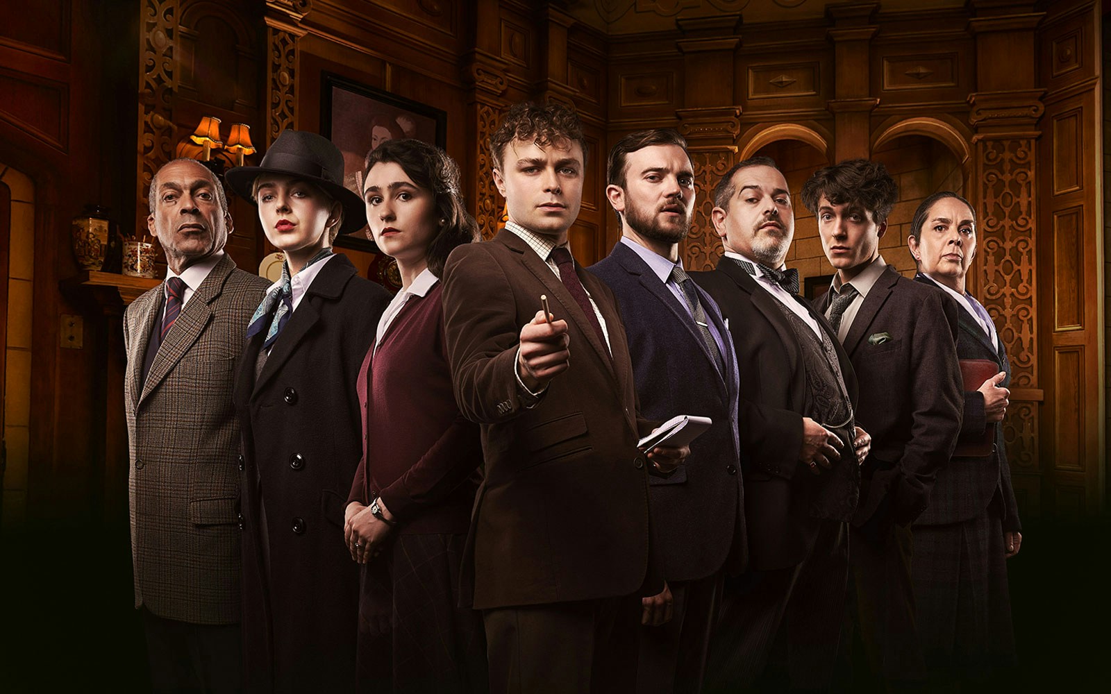 Cast of "The Mousetrap" in period costumes on stage.