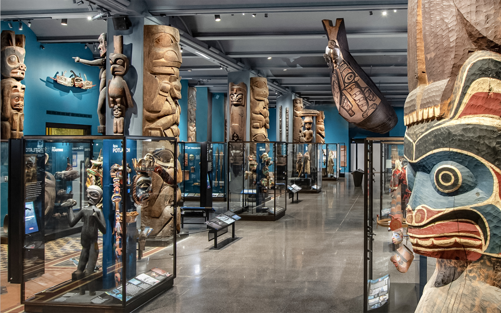 Native American totem poles and artifacts in the American Museum of Natural History exhibit hall.