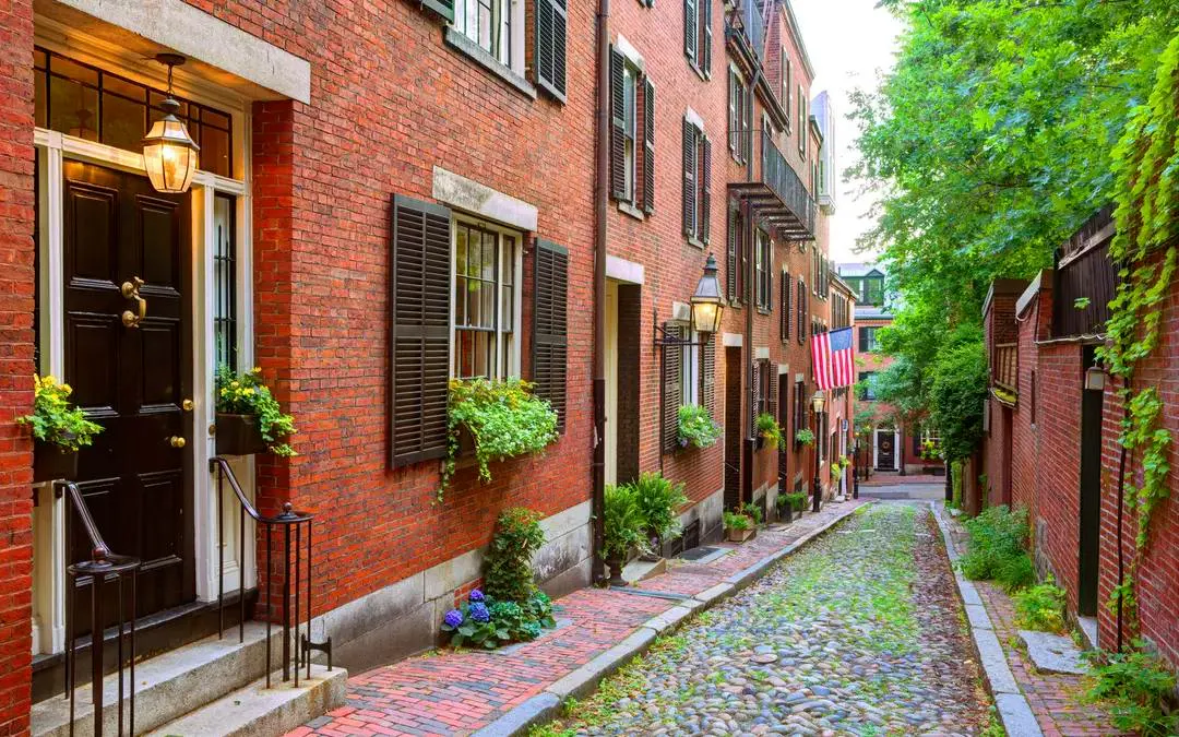 Cobblestone street with historic brick buildings in Boston's North End.