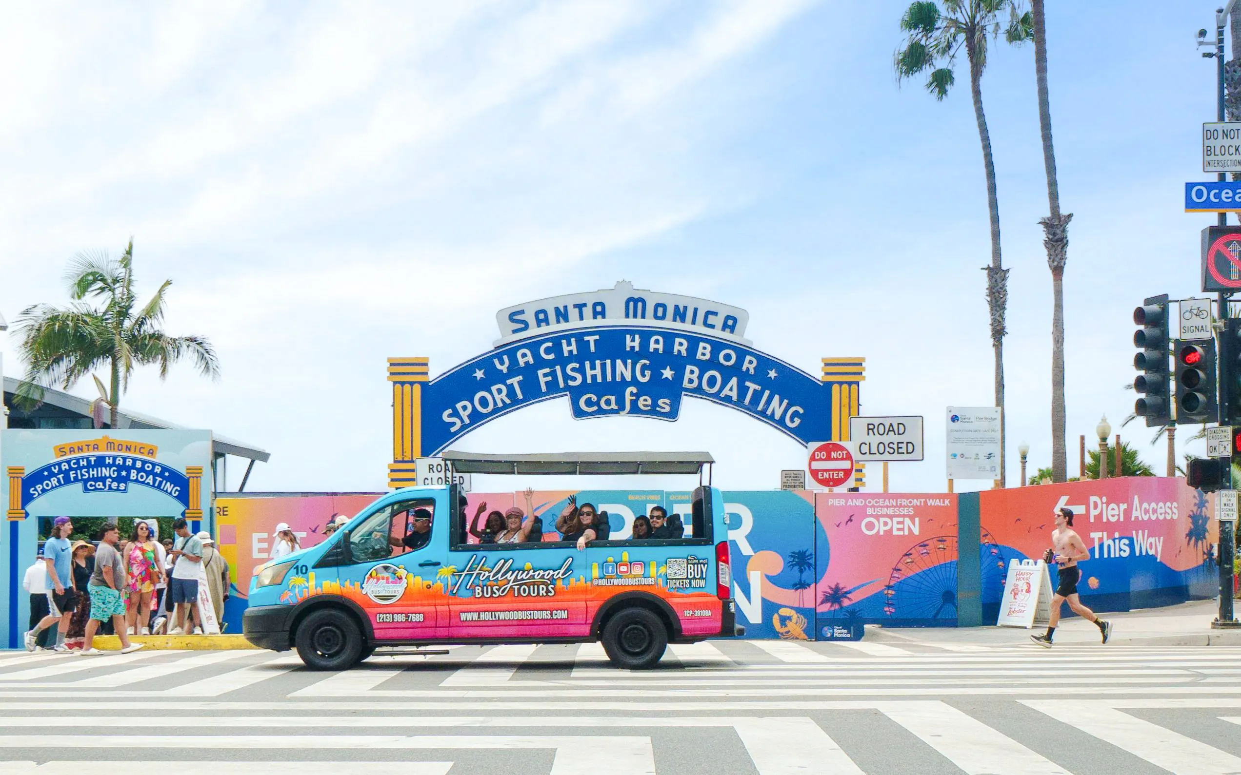 Tour bus at Santa Monica Pier entrance on Malibu Beaches and Pacific Coast Highway tour.